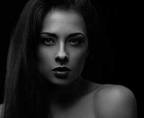 Fototapeta premium Beautiful makeup woman with long hair looking sexy on black background in darkness. Closeup portrait. Art.Expression portrait. Vogue.