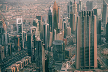 Dubai skyline, skyscrapers from above in morning light. Downtown and financial center with luxury towers and hotels, United Arab Emirates.