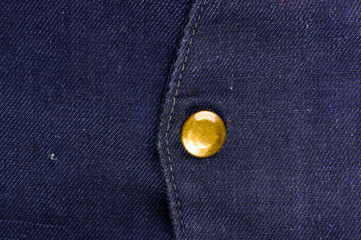 clothing items stonewashed cotton fabric texture with seams, clasps, buttons and rivets, macro