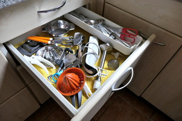 Kitchen utensils in an open drawer
