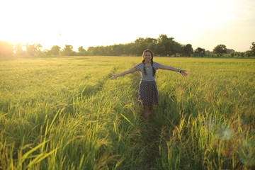 A woman standing in a rice field in Rayong, Thailand © pantkmutt