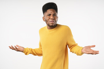 Angry and mad african man standing over white background