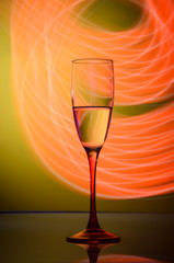 Champagne glass on yellow background with lights