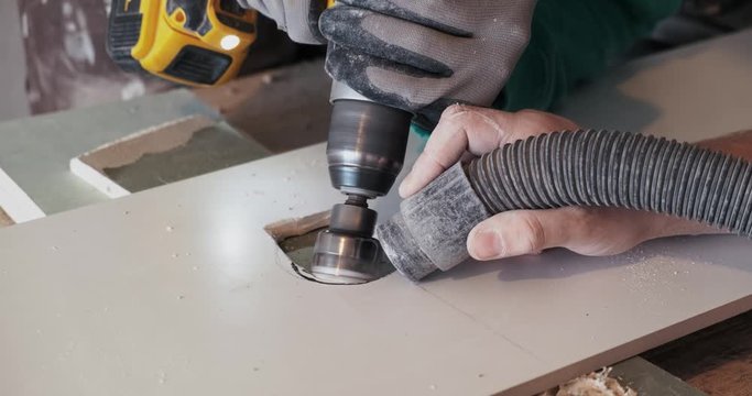 Two people cut holes in ceramic tiles, work with drill, suction flying dust with hose, ceramic preparation technology, cylindrical drill, preparatory work, rectangular, construction site, repair work