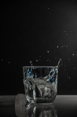 glass of water with splash on black background