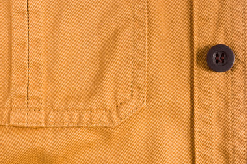 clothing items stonewashed cotton fabric texture with seams, clasps, buttons and rivets, macro