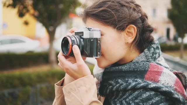 Adorable and interested girl is taking photoes. Crop. Copy space. Action. Motion. 4K.