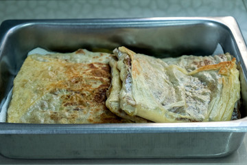 "Murtabak" or pancake with mixed meat or chicken and vegetable in the tray
