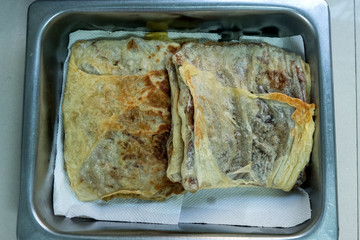 "Murtabak" or pancake with mixed meat or chicken and vegetable in the tray