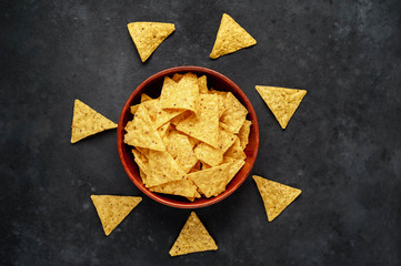 Mexican nachos chips in a bowl on a stone background with copy space for your text