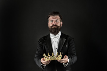 Reputation and status. Glory and ambitions. King crown. Royal coronation symbol. Now come and make it worth. Crown in hands. Handsome man give crown black background. Getting reward. Crowning glory - obrazy, fototapety, plakaty