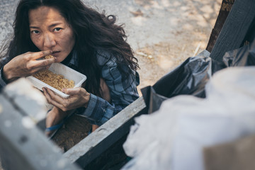 poor people,homeless or beggar begging for help sitting at dirty slum.concept for poverty...