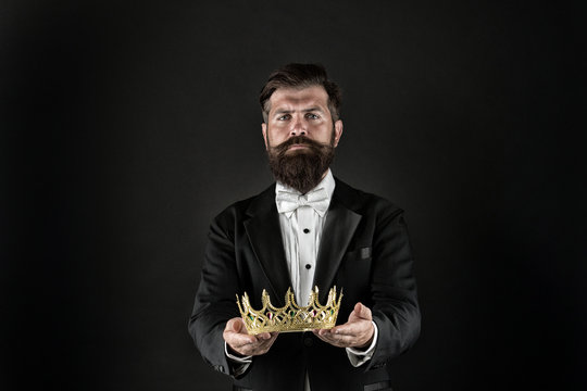 Reputation and status. Glory and ambitions. King crown. Royal coronation symbol. Now come and make it worth. Crown in hands. Handsome man give crown black background. Getting reward. Crowning glory