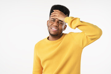Young man with disgusted expression repulsing something over white background