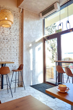 The Cafe Entrance With Glass Door And Large Glass Windows.