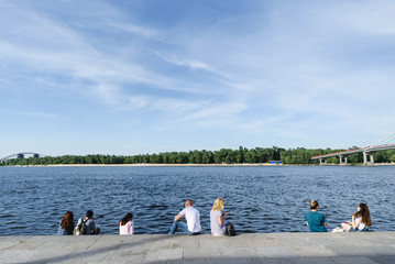 Fototapeta na wymiar group of people sitting at the river