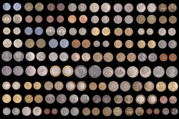 Set of different coins on a black background. Stock photo assortment of coins of different countries. 