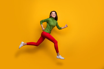 Fototapeta na wymiar Full size photo of positive cheerful girl jump run fast after black friday sales wear casual style clothes white sneakers isolated over vibrant color background