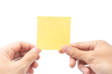 Obraz premium Close up hand holding empty yellow paper note isolated on white background with clipping path. remind to do list, office supplies note message, office and bussiness concept.