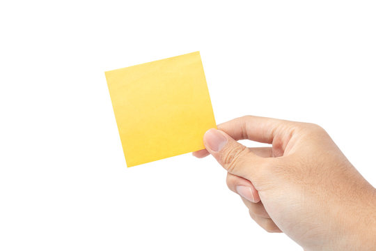 Close up hand holding empty yellow paper note isolated on white background with clipping path. remind to do list, office supplies note message, office and bussiness concept.