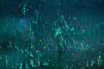 Texture of a rusty metal surface with white, green, salt, evergreen, dark blue, blue, aged cracked paint. Rusty and scratched painted metal wall