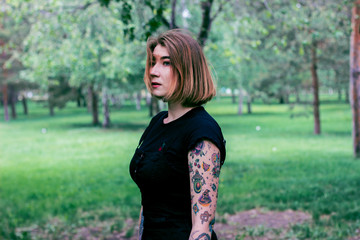 Tattoo girl walking on the streets and forest