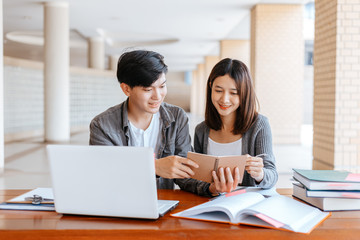 High school or college students  group catching up workbook and learning tutoring on desk and reading, doing homework, lesson practice preparing exam.