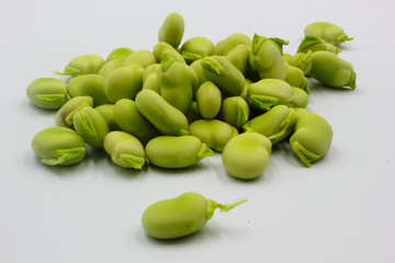 pile of fresh shelled broad beans isolated on a white background