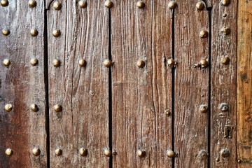 Gate of an old medieval castle, old thick wooden lumber