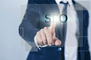 Search Engine Optimization consultant touching SEO button