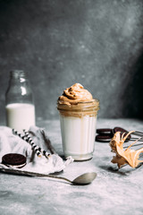 Dalgona coffee in a glass. Korean coffee and milk drink.