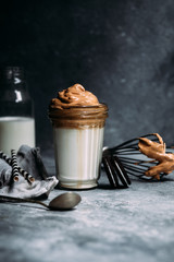 Dalgona coffee in a glass. Korean coffee and milk drink.