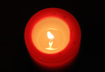 red candle with black background (view from top)