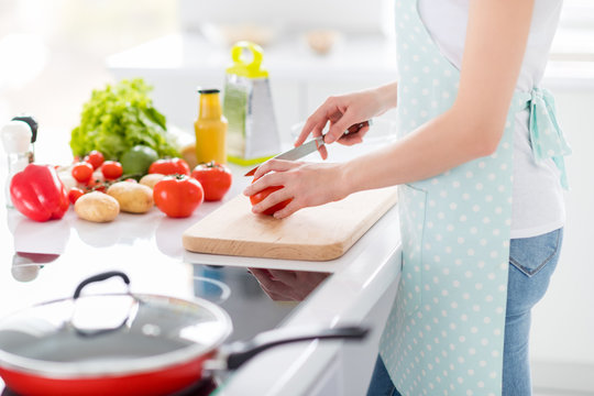 Cropped Profile Photo Of Housewife Chef Arms Holding Tomato Cutting Knife Slices Enjoy Morning Cooking Tasty Dinner Family Meeting Wear Apron T-shirt Stand Modern Kitchen Indoors