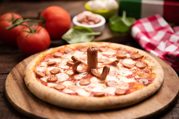 Homemade pizza with wurstel and mozzarella cheese
