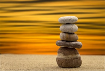 Zen stones balanced on the beach