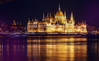 Obraz premium Scenic image of Hungarian parliament with reflections, Budapest with colorful dramatic sky during sunset. Fantastic view on Budapest sityscape. wonderful picturesque Scene. Popular Travel destinations