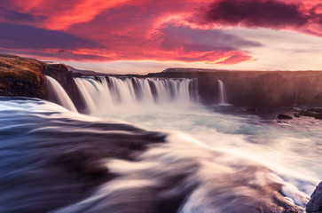 Gorgeous nature scenery. Godafoss waterfall with colorful overcast sky during sunset. Iceland,...