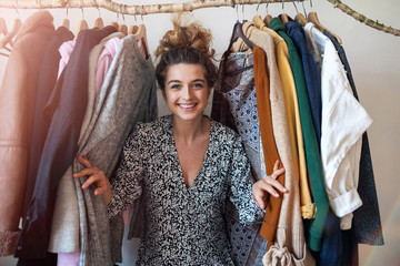 Fototapeta premium Young woman choosing clothes 