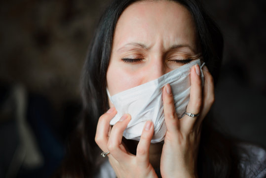 Girl At Home In A Protective Mask Tries To Rip Her Off