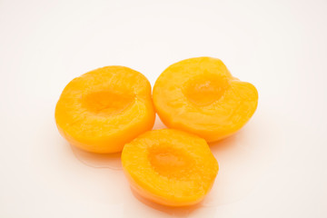 Fototapeta na wymiar Peaches in syrup and cut in halves.