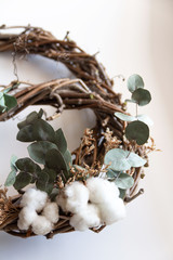 handmade wreath made of twigs, eucalyptus and cotton