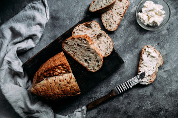 Whole grain bread with flax seeds on the table. A sandwich