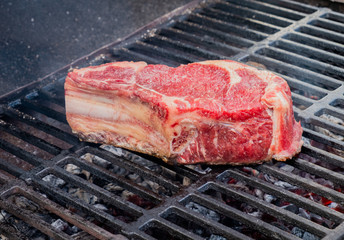 Put for cooking raw beef steak on a hot grill