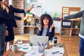 Group of business workers working together. Partners stressing one of them at the office