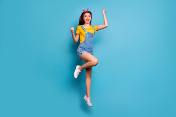 Fototapeta na wymiar Full length body size view of her she nice attractive lovely charming cheerful cheery glad lucky girl jumping having fun celebrating isolated over bright vivid shine vibrant blue color background