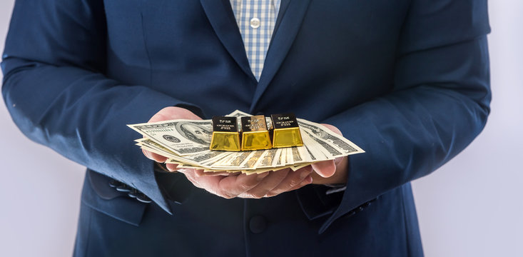 Man In Suit Hold Money Dollar Bills And Gold Bar