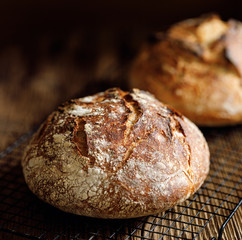 Traditional sourdough loaf of bread  on a  on a cooling tray, close up