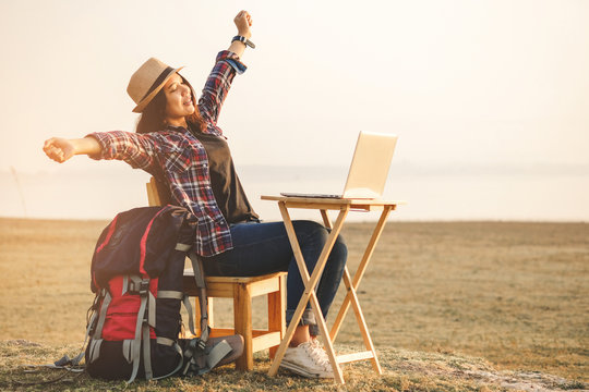Businesswoman working on laptop is outside in early morning, she is young and attractive girl. Work from anywhere lifestyle. Freedom, freelance