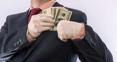 Business person Hand in blue protective gloves with money isolated on white background.